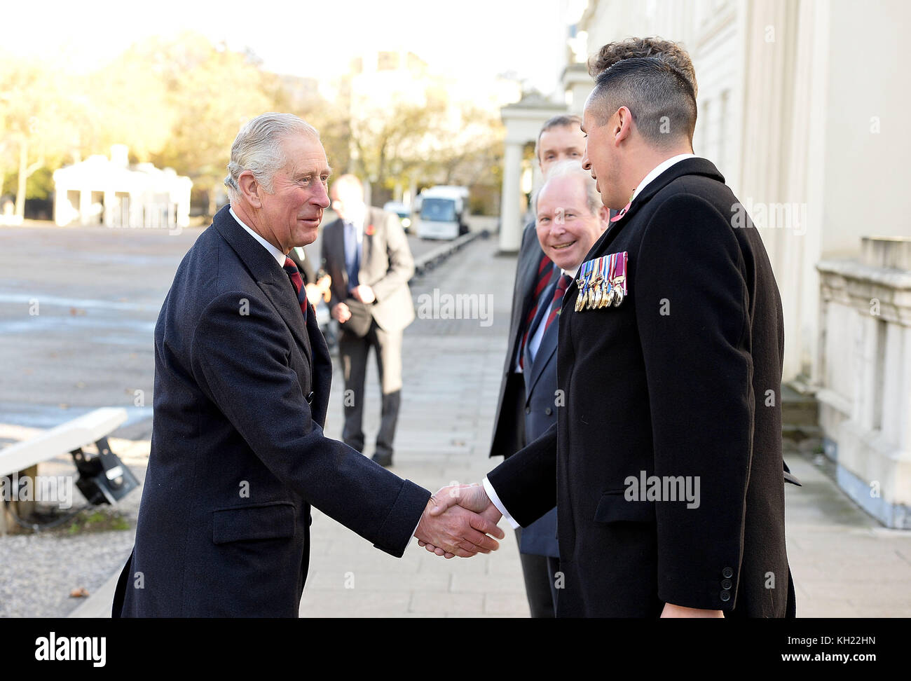 The Prince of Wales (left) is greeted by Colonel Tom Bonas and WSM Dean Morgan as he arrives at the Guards' Memorial at the Guards' Chapel, Wellington Barracks, London, for the Welsh Guards' Regimental Remembrance Sunday. Stock Photo