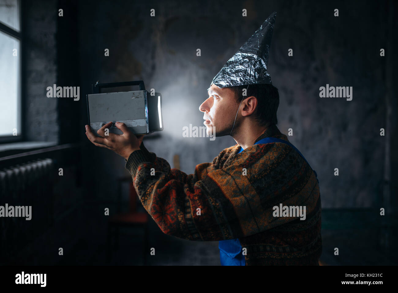 Paranoid man in tinfoil cap, mind protection, UFO Stock Photo