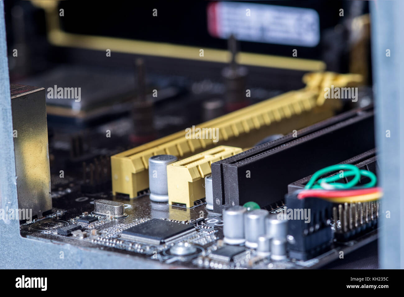 Computer motherboard PCI slots, capacitors and transistors, closeup Stock Photo