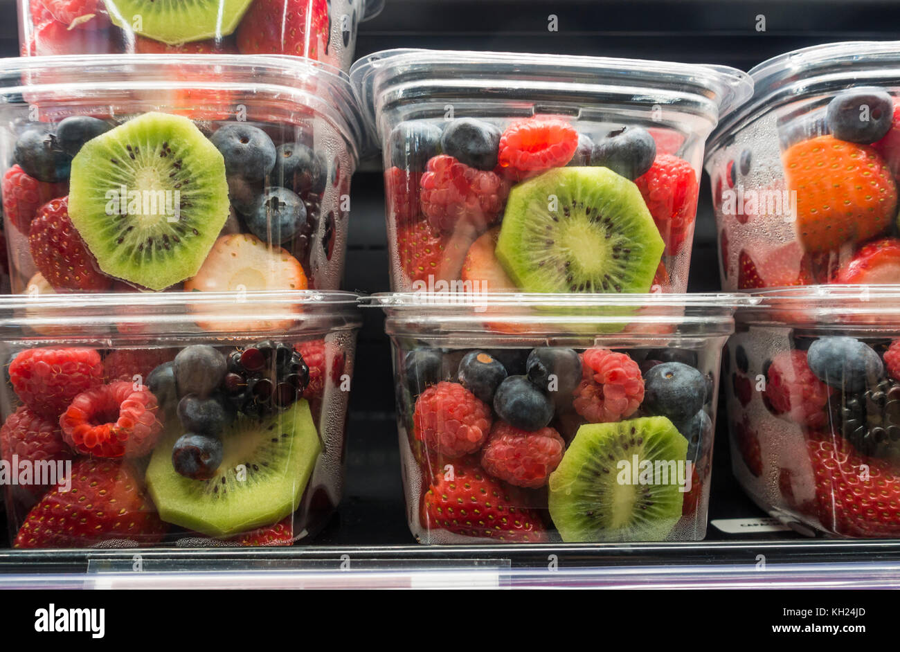 https://c8.alamy.com/comp/KH24JD/clear-plastic-containers-of-mixed-cut-fresh-fruit-on-the-shelf-in-KH24JD.jpg