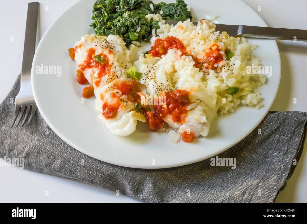 Grilled cod with spinach and rice Stock Photo - Alamy