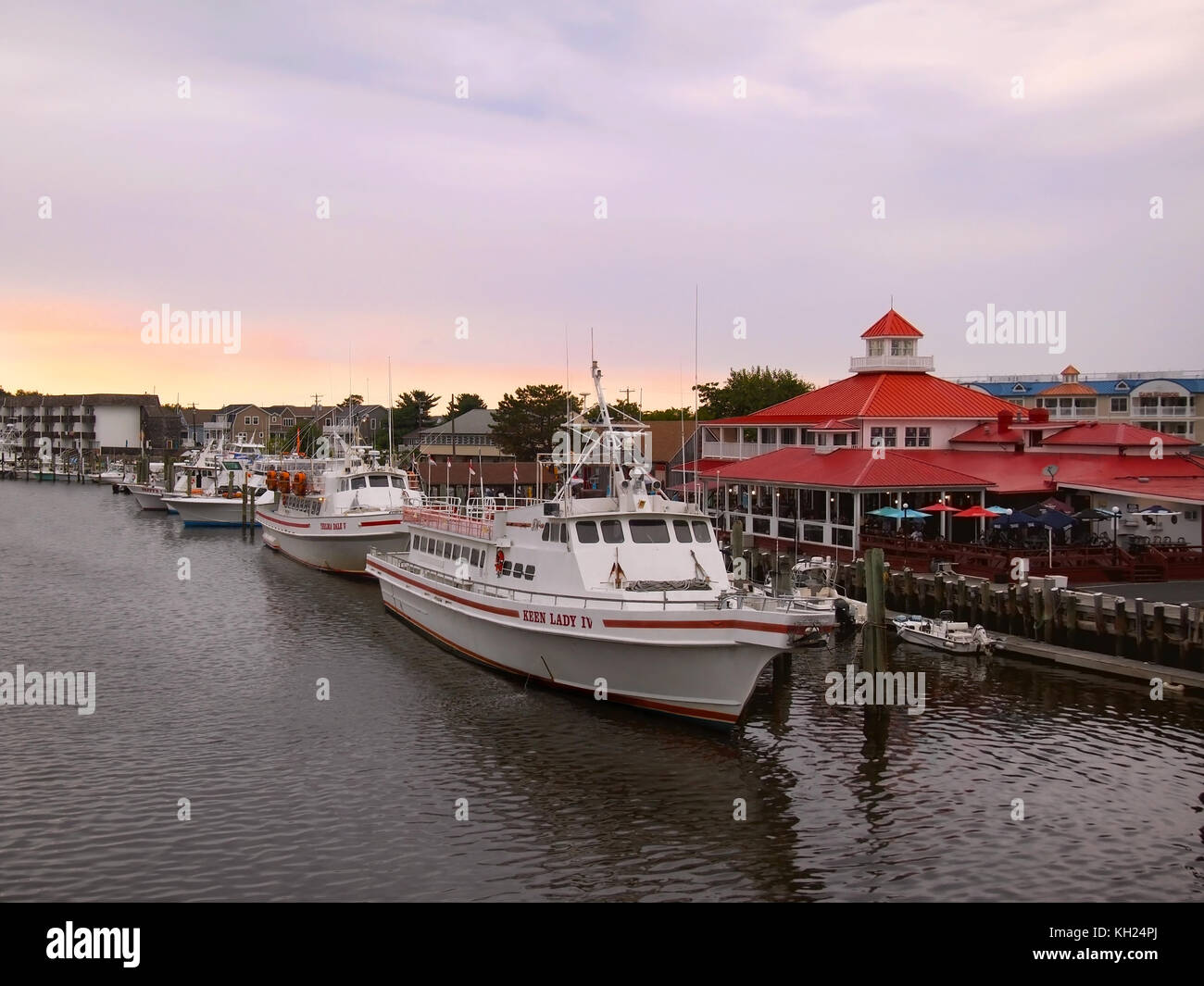 LEWES, DELAWARE - AUGUST 29, 2017: Tour boats and fishing boats are moored in the harbor at sunset in Lewes, Deleware, a United States eastern shore t Stock Photo