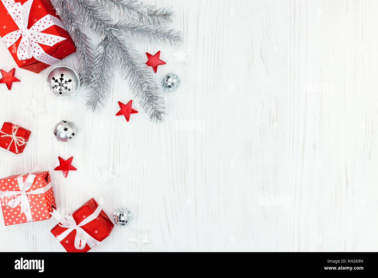 christmas tree decorations, silver tree branch and gift boxes on white ...
