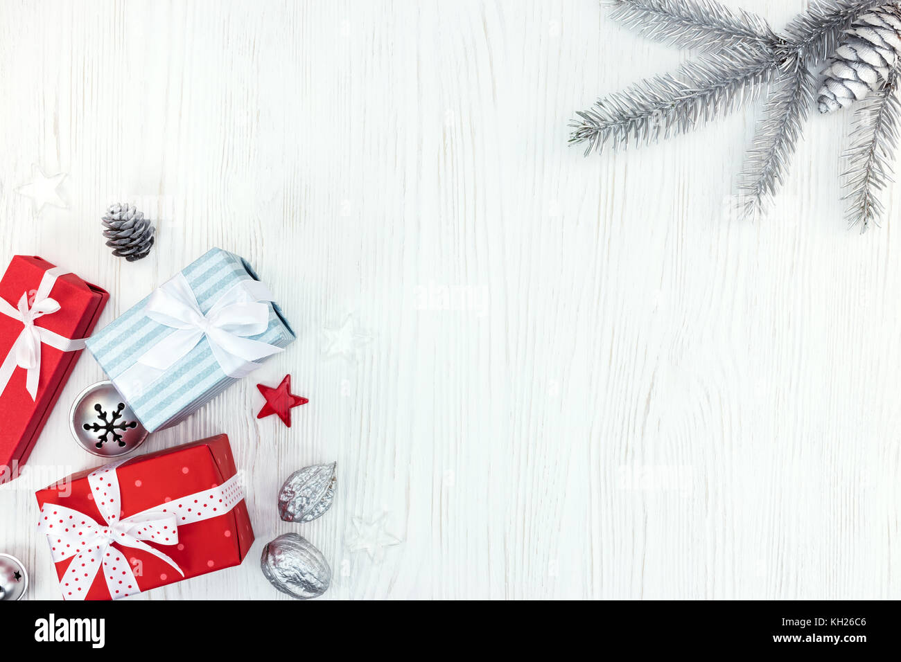 christmas wooden background with fir tree branch, gift boxes and ...