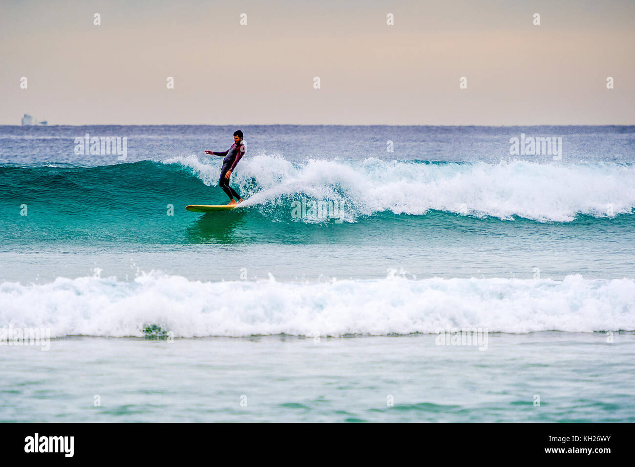 A surfer ride a wave at Sydney's iconic Bondi Beach, NSW, Australia Stock Photo