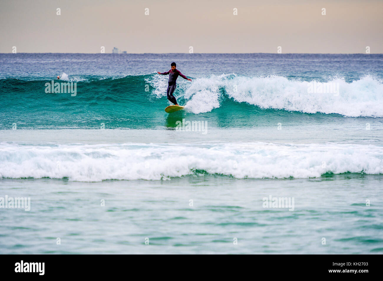 A surfer ride a wave at Sydney's iconic Bondi Beach, NSW, Australia Stock Photo