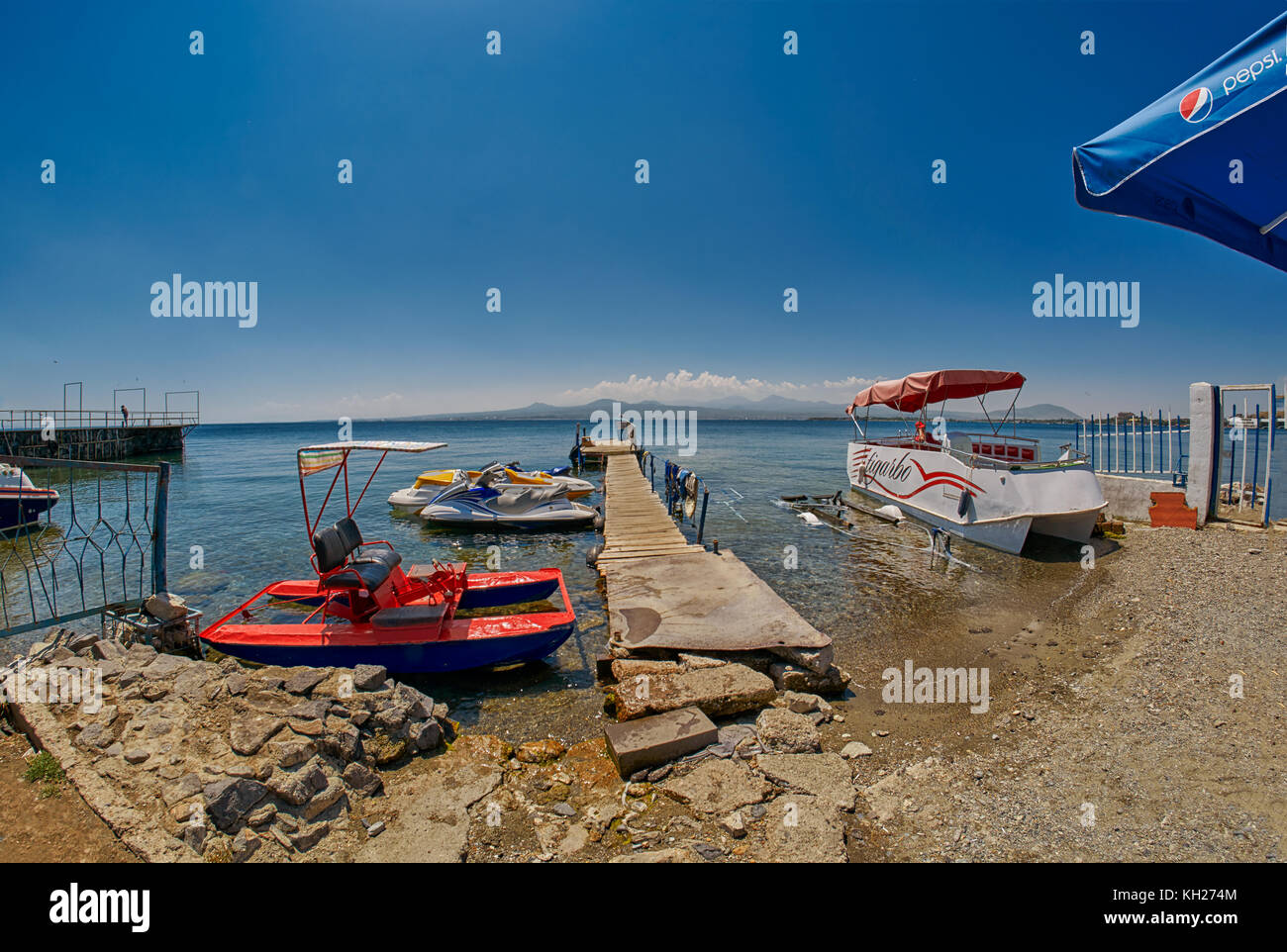 SEVAN LAKE, ARMENIA - 02 AUGUST 2017: Beach and Watersports Boats at Mountain Lake of Sevan in Armenia Stock Photo
