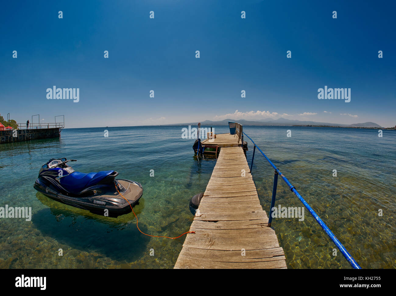 SEVAN LAKE, ARMENIA - 02 AUGUST 2017: Wooden pier on Transparent waters of Mountain Lake Sevan of Armenia Stock Photo