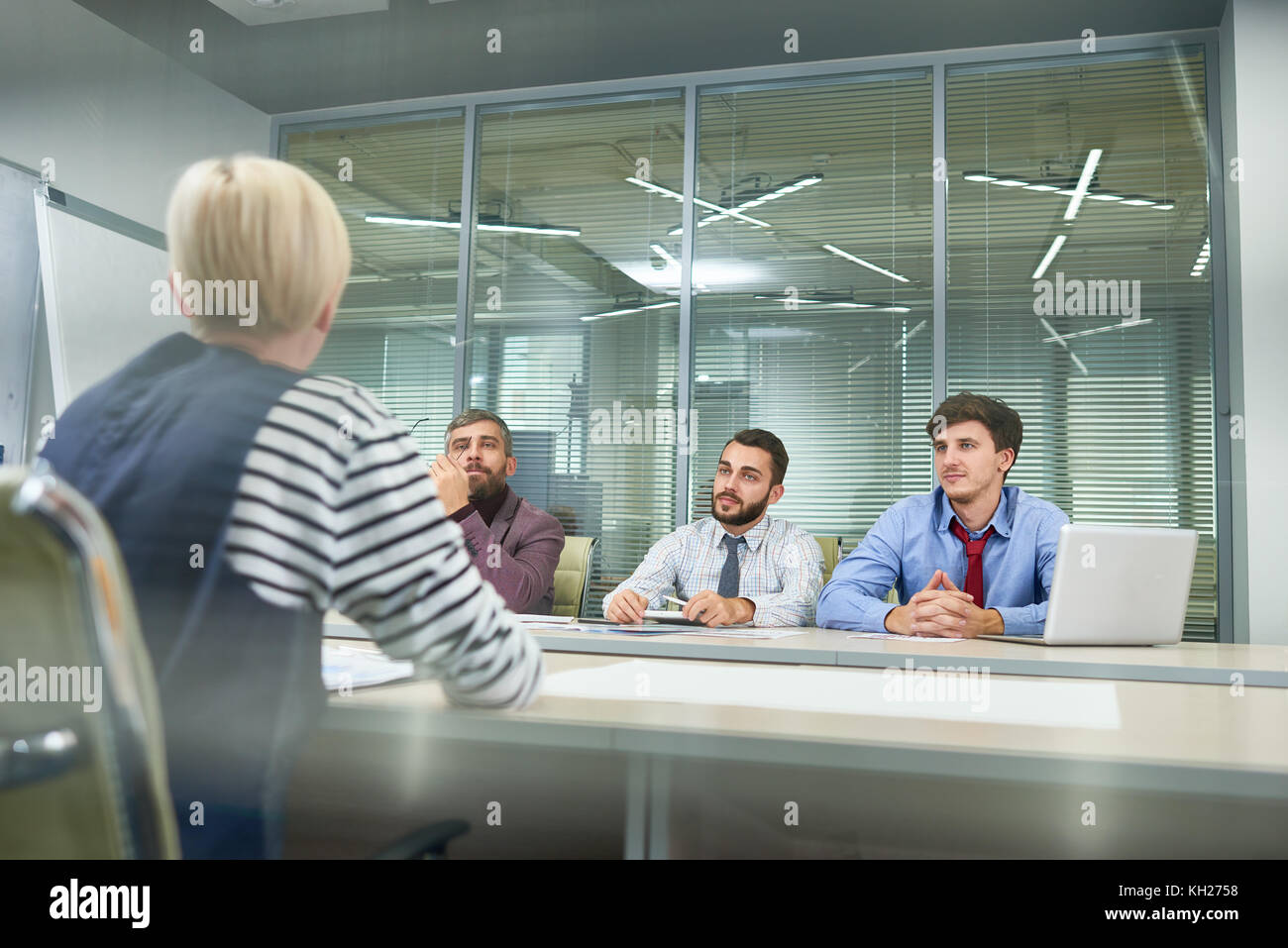 Group of business people sitting at meeting table discussing work in ...