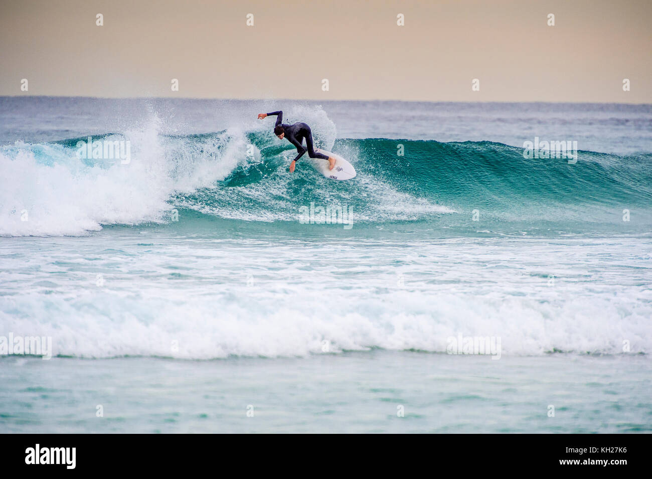 A surfer ride a wave at Sydney's iconic Bondi Beach, NSW, Australia Stock Photo