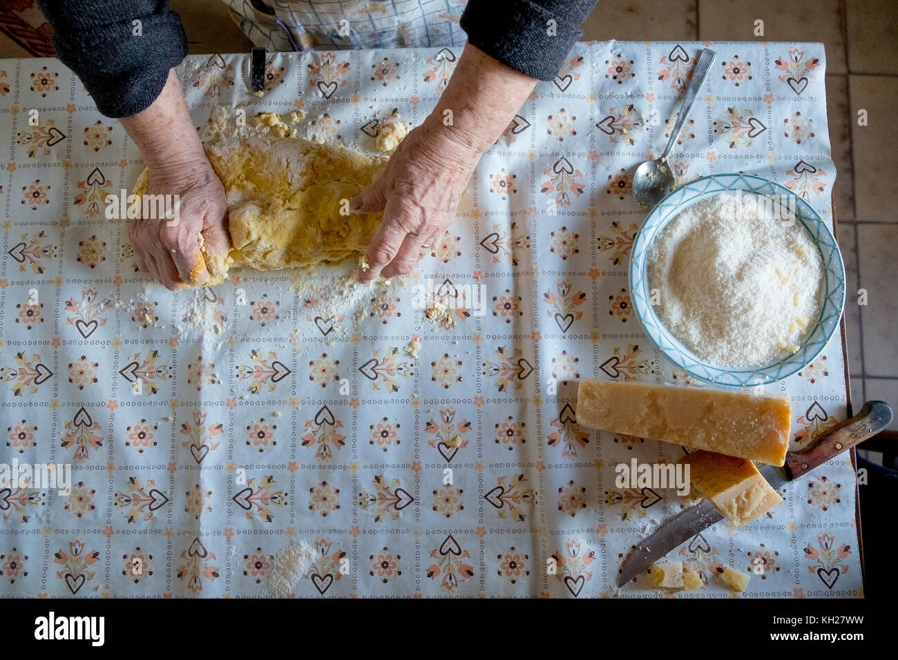 old woman making homemade pasta with parmesan cheese Stock Photo