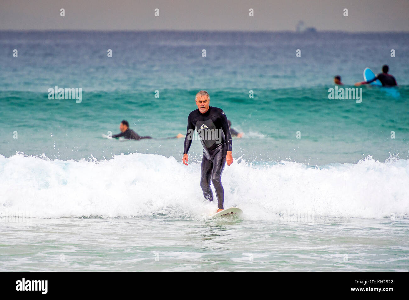 A surfer ride a wave at Sydney's iconic Bondi Beach, NSW, Australia Stock Photo