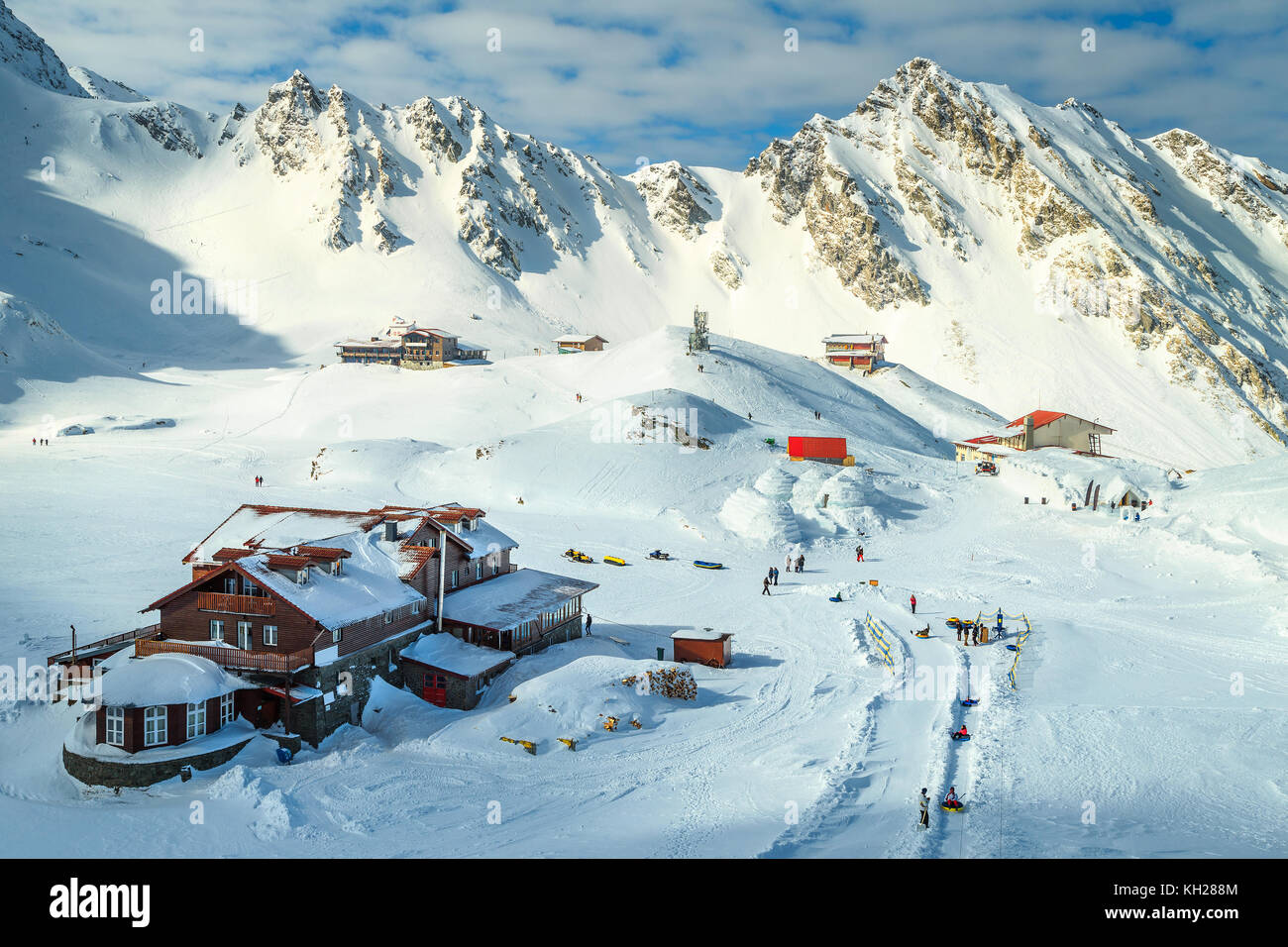 Wonderful winter landscape in Fagaras mountains with famous frozen Balea lake and wooden houses, Carpathians, Transylvania, Romania, Europe Stock Photo