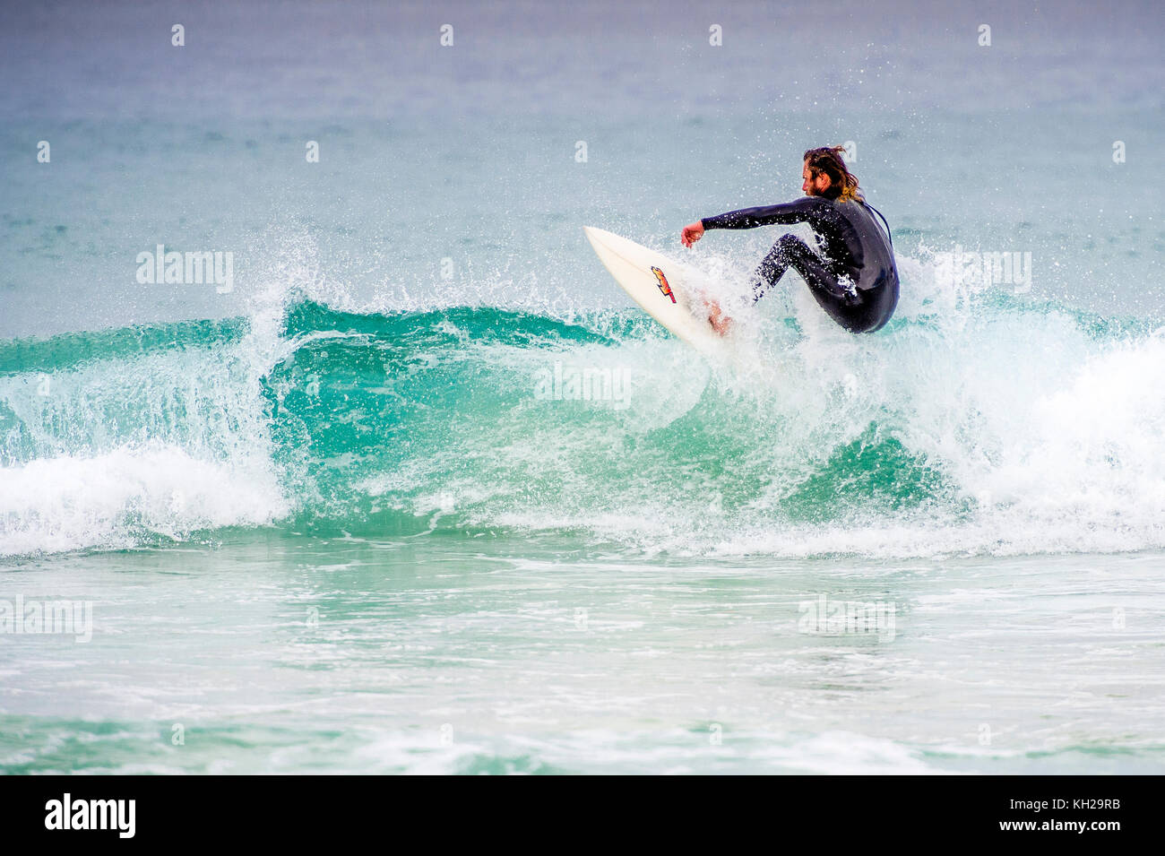 A surfer ride a wave at Sydney's iconic Bondi Beach, NSW, Australia Stock Photo