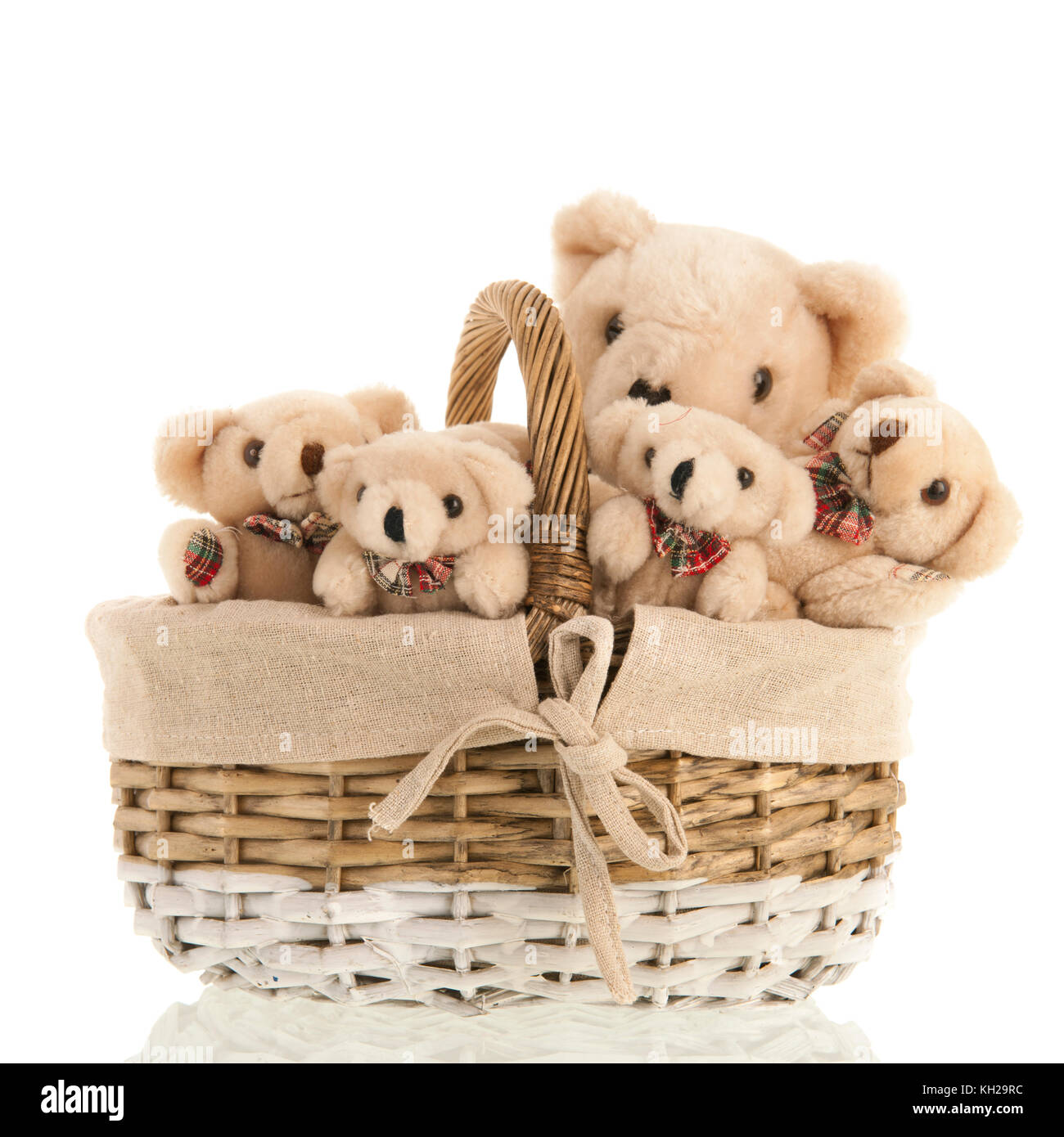 Group stuffed bears together in wicker basket isolated over white background Stock Photo
