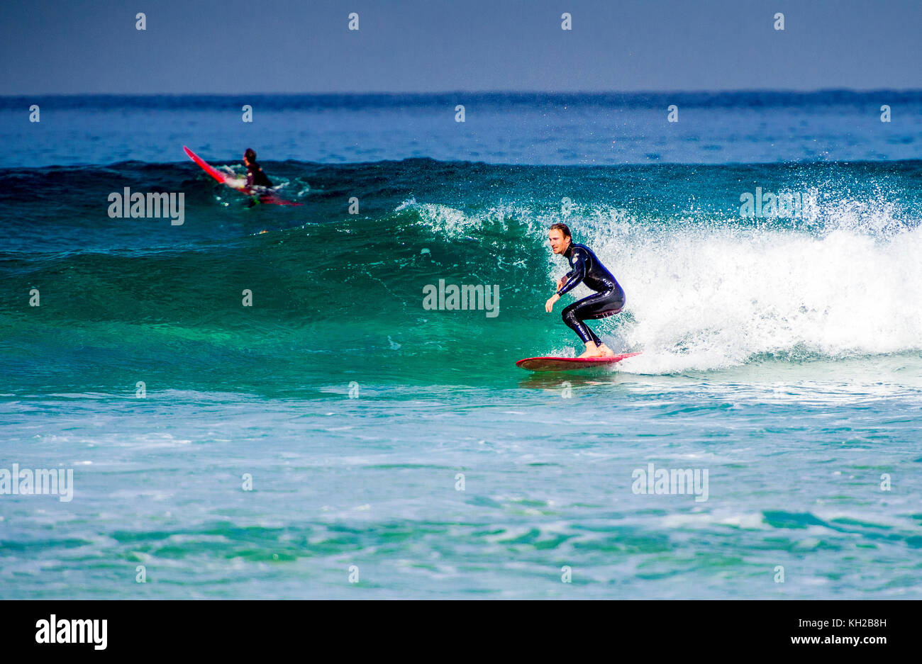 A surfer ride a wave at Sydney's iconic Bondi Beach, NSW, Australia Stock Photo