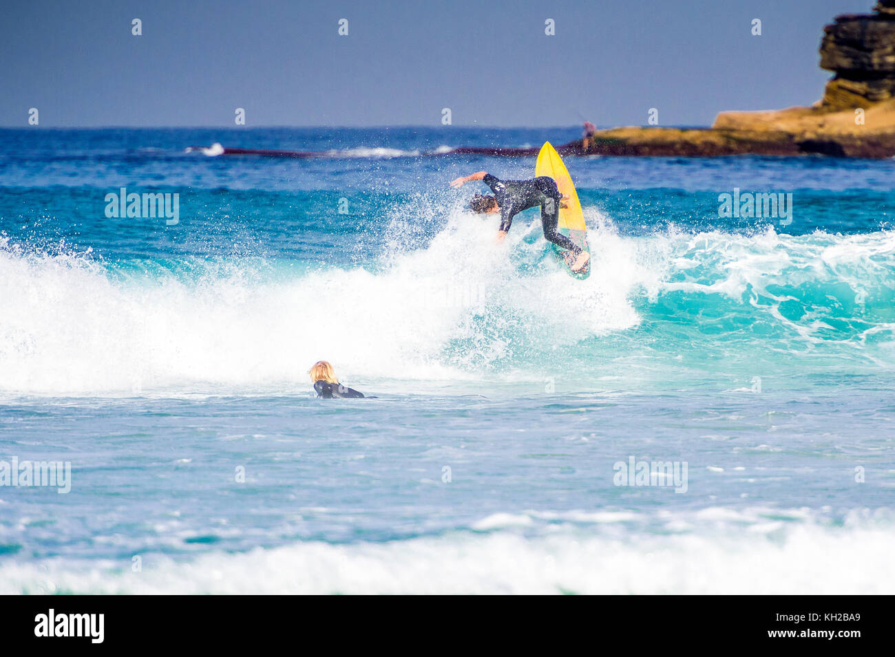 A surfer ride a wave at Sydney's iconic Bondi Beach, NSW, Australia Stock Photo