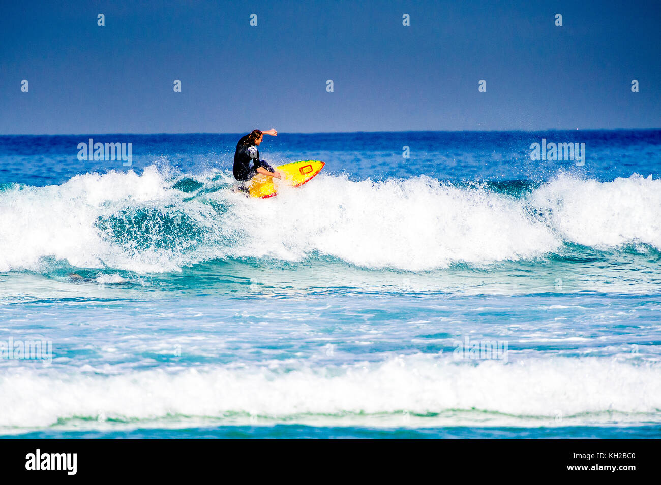 A surfer ride a wave at Sydney's iconic Bondi Beach, NSW, Australia Stock Photo