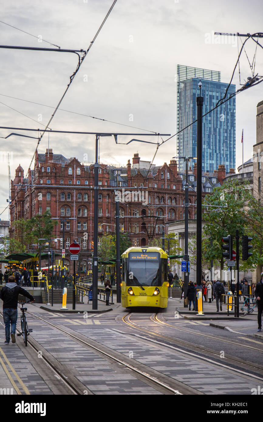 St Peter's Square Tram Station with Tram departing and The Midland Hotel & Beetham Tower in the background. Stock Photo
