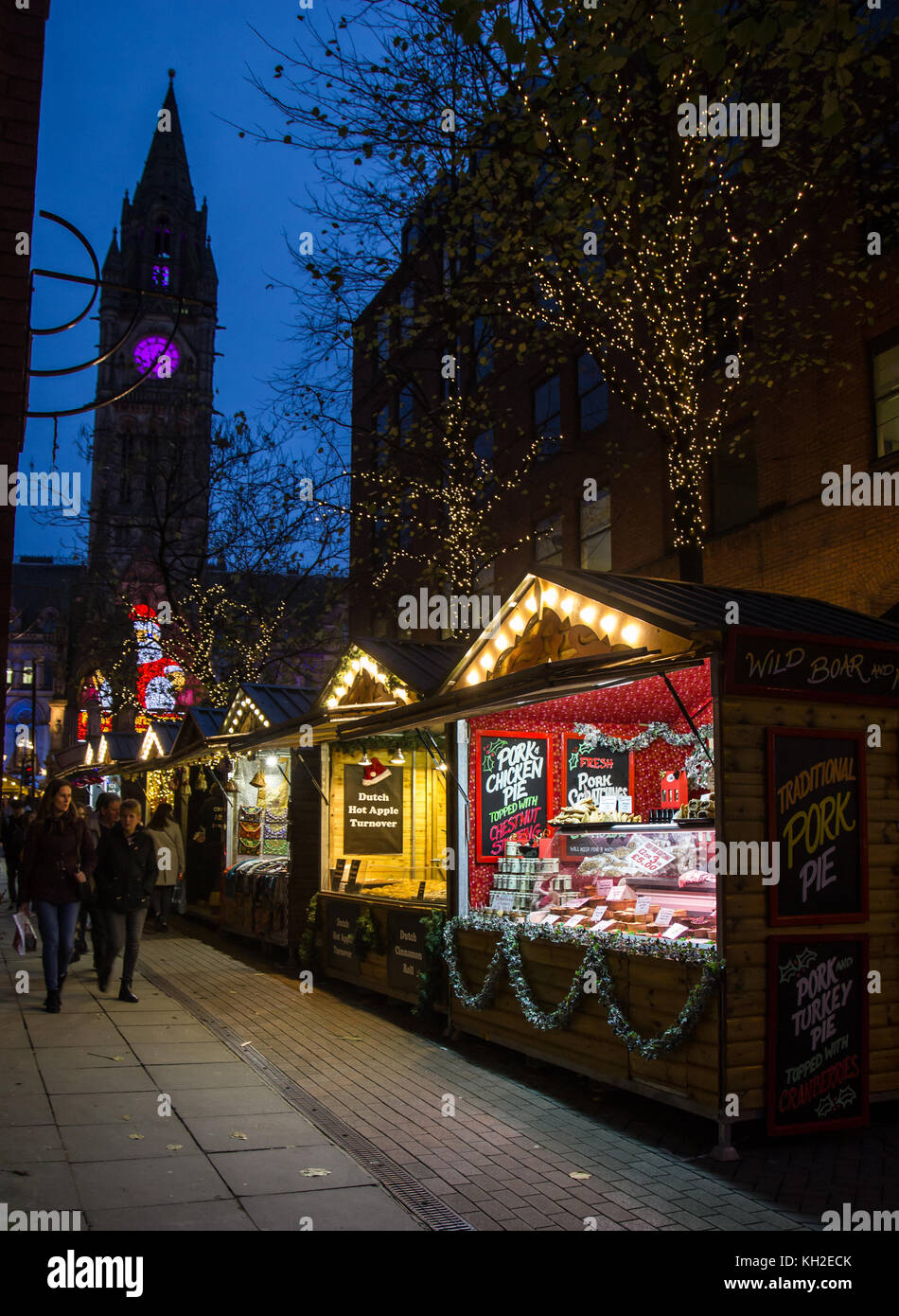 Christmas Market Stalls at the top of Brazennose street, Manchester, UK and town hall clock in the background Stock Photo