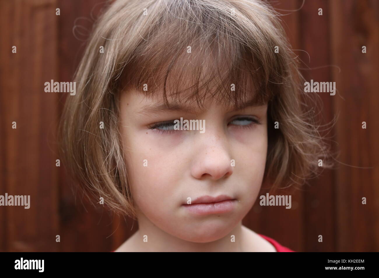 Portrait of a young girl rolling her eyes Stock Photo