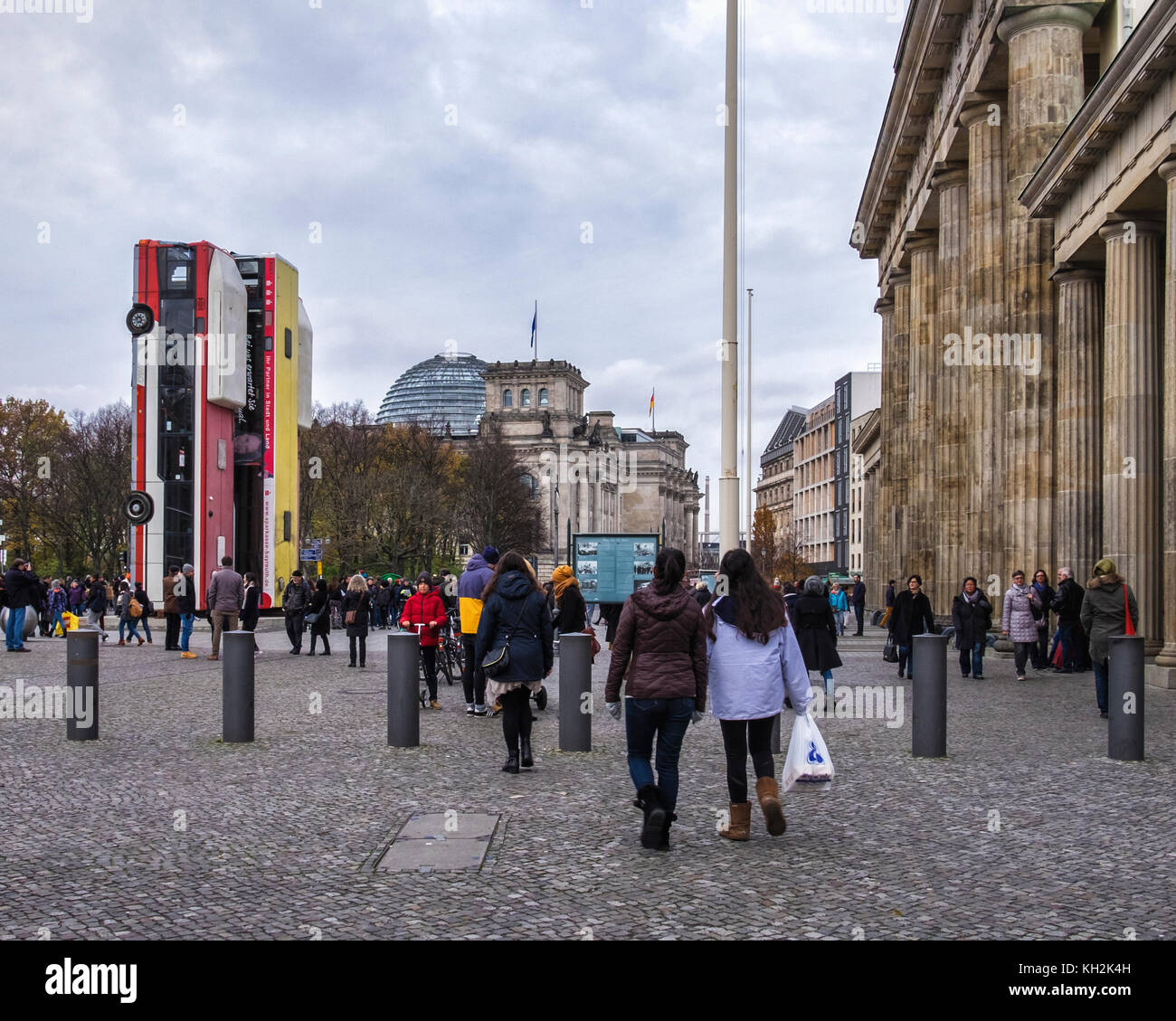 Berlin, Mitte. 12th November, 2017. Installation artwork 'Monument' by German-Syrian artist Manaf Halbouni in front of the Brandenburg Gate. Three upended buses form a defensive barricade like the barriers erected in Aleppo Syria to protect people from snipers. The artwork is part of the third Herbstsalon event by the Maxim Gorki theatre. Credit: Eden Breitz/Alamy Live News Stock Photo