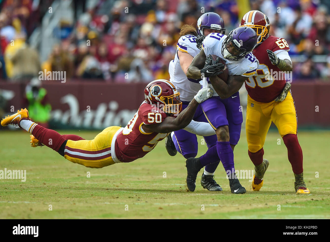 Landover, MD, USA. 12th Nov, 2017. Washington Redskins linebacker Martrell Spaight (50) and linebacker Junior Galette (58) try to bring down Minnesota Vikings running back Jerick McKinnon (21) during the matchup between the Minnesota Vikings and the Washington Redskins at FedEx Field in Landover, MD. Credit: csm/Alamy Live News Stock Photo
