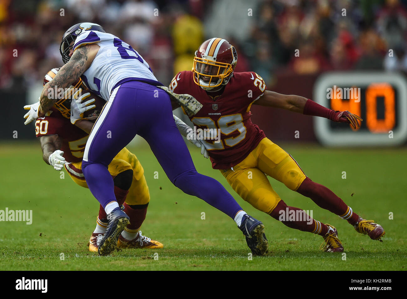 Landover, MD, USA. 12th Nov, 2017. Washington Redskins linebacker Martrell Spaight (50) and cornerback Kendall Fuller (29) tackle Minnesota Vikings tight end Kyle Rudolph (82) during the matchup between the Minnesota Vikings and the Washington Redskins at FedEx Field in Landover, MD. Credit: csm/Alamy Live News Stock Photo
