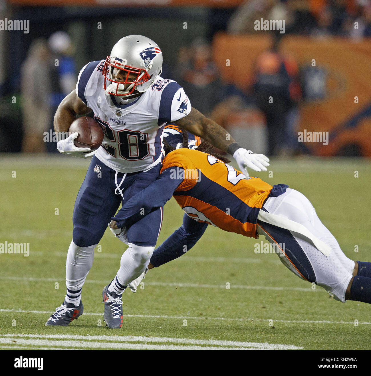 Denver, Colorado, USA. 12th Nov, 2017. Patriots RB JAMES WHITE, left, gets tackled by Broncos CB BRADLEY ROBY, right, during the 2nd. half at Sports Authority Field at Mile High Sunday night in Denver, CO. The Patriots beat the Broncos 41-16. Credit: Hector Acevedo/ZUMA Wire/Alamy Live News Stock Photo