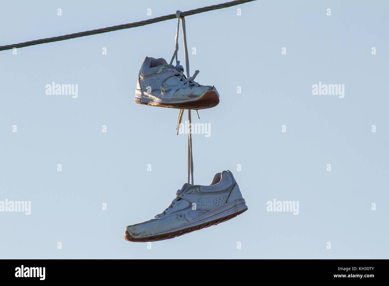 Pair of shoes hanging from electric wires Stock Photo