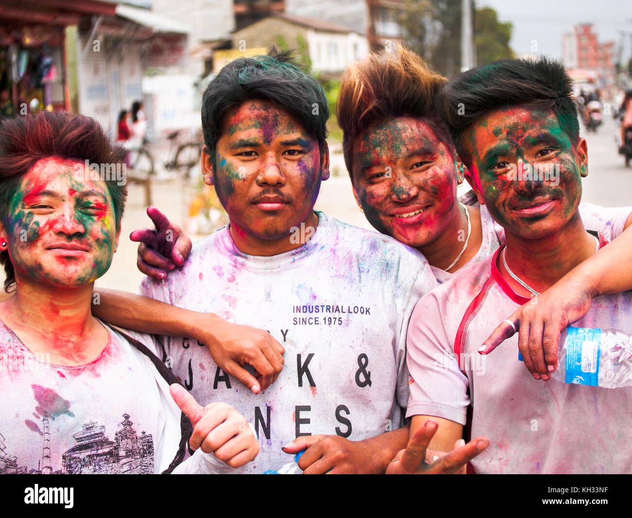 Nepali youths covered with coloured powder after celebrating the Hindu festival Holi in Pokhara, Nepal Stock Photo