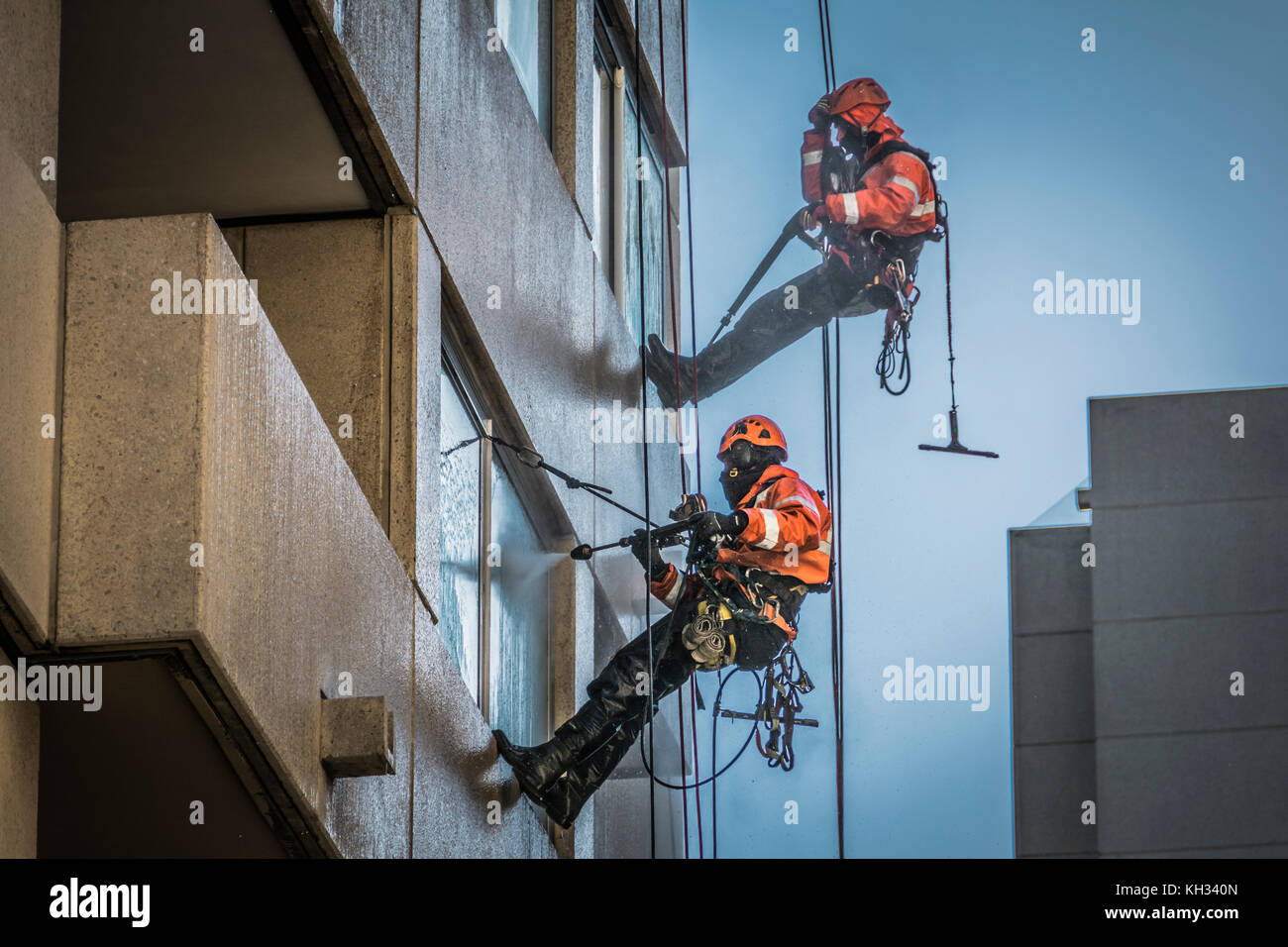 Window cleaners with high pressure hoses on a highrise development in