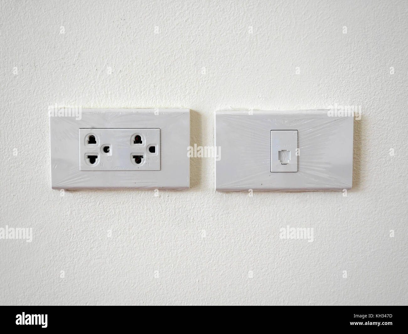 Southeast Asia power outlet and phone jack, newly installed with