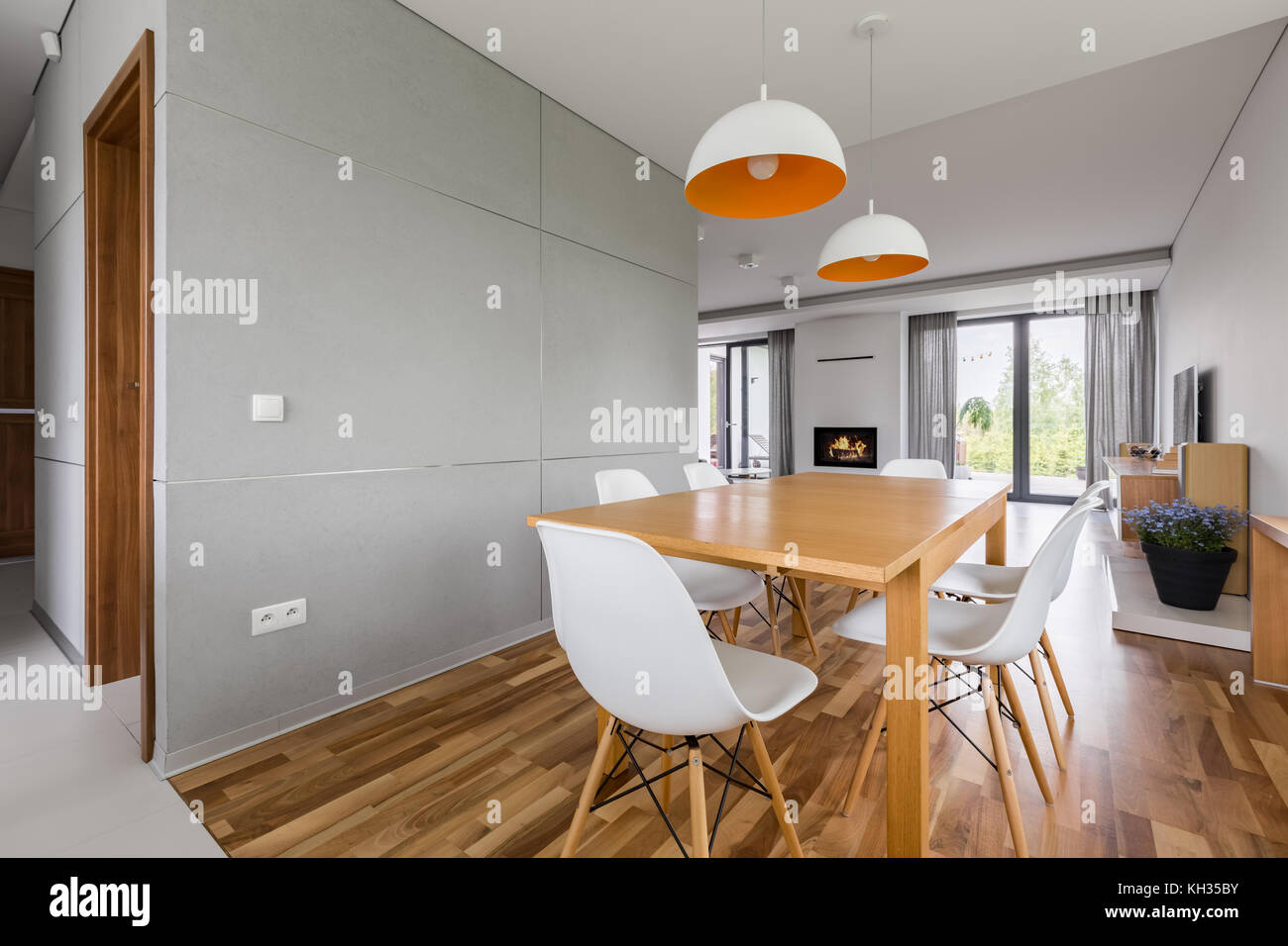 Modern home interior with wooden table and white chairs Stock Photo - Alamy