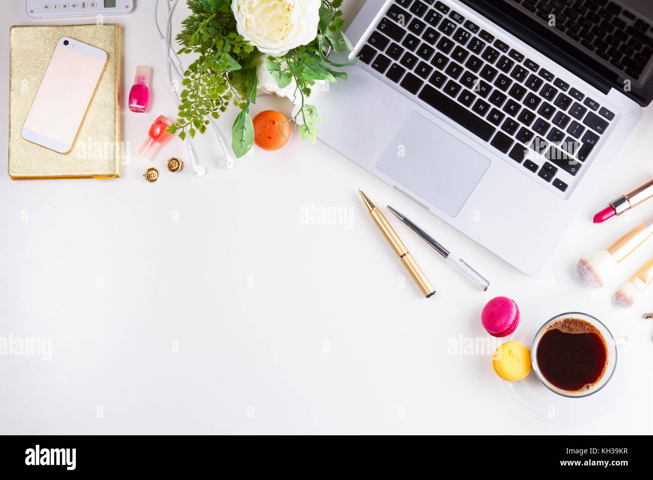 Feminine workspace border with keyboard, coffee and flowers, top view ...