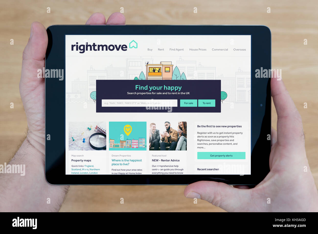 A man looks at the Rightmove website on his iPad tablet device, shot
