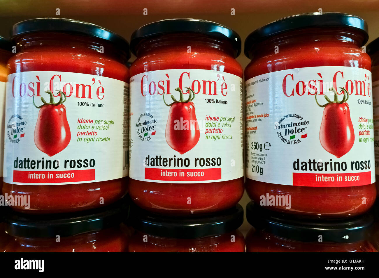 Tomato passata puree sauce for pasta displayed for sale. Peeled tomatoes sauce jars aligned on a shelf. Mediterranean healthy diet. Close up. Stock Photo