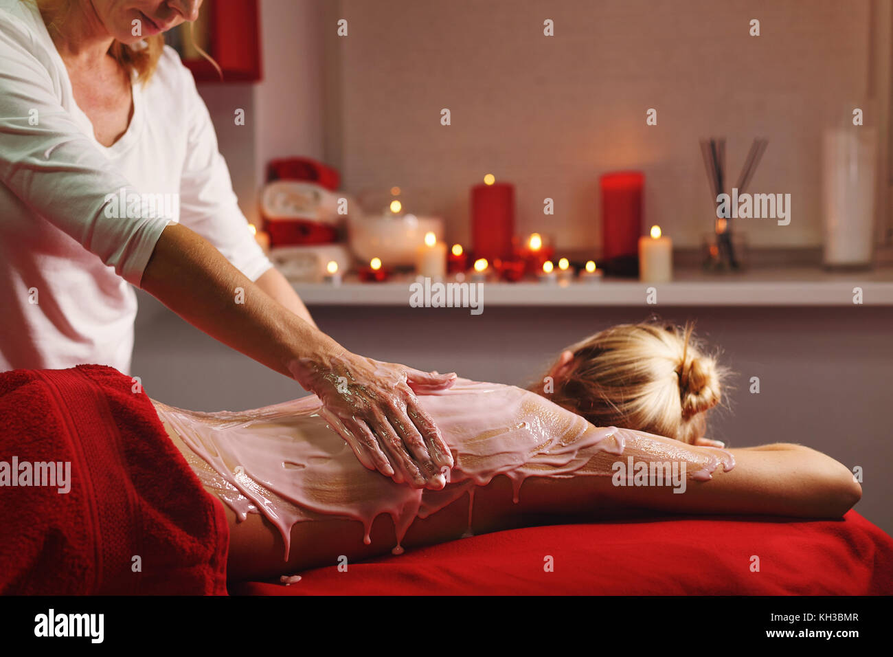 Spa treatment. Back massage with a moisturizing mask. The process of
