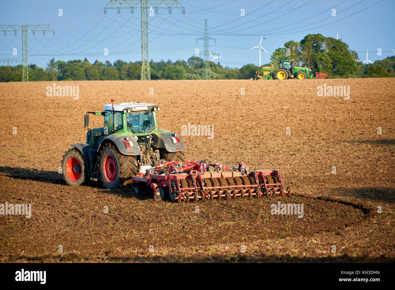 earth preparation after harvesting with tractor Stock Photo - Alamy