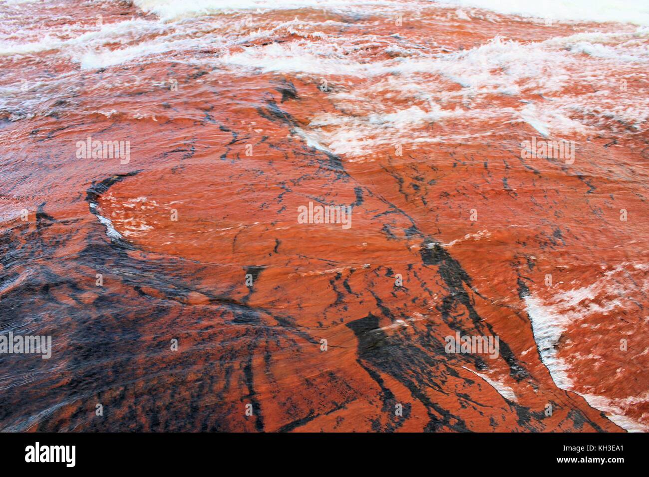 Water flowing over beautiful red jasper surface Stock Photo Alamy