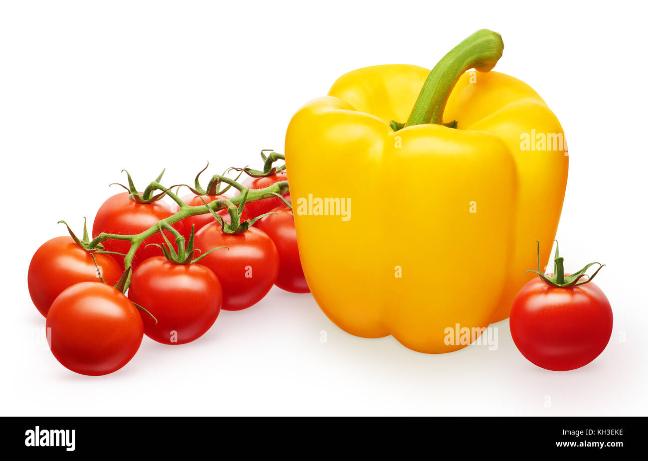 Whole fresh yellow bell pepper, branch of red cherry tomatoes with green leaves and single tomato isolated on white background Stock Photo