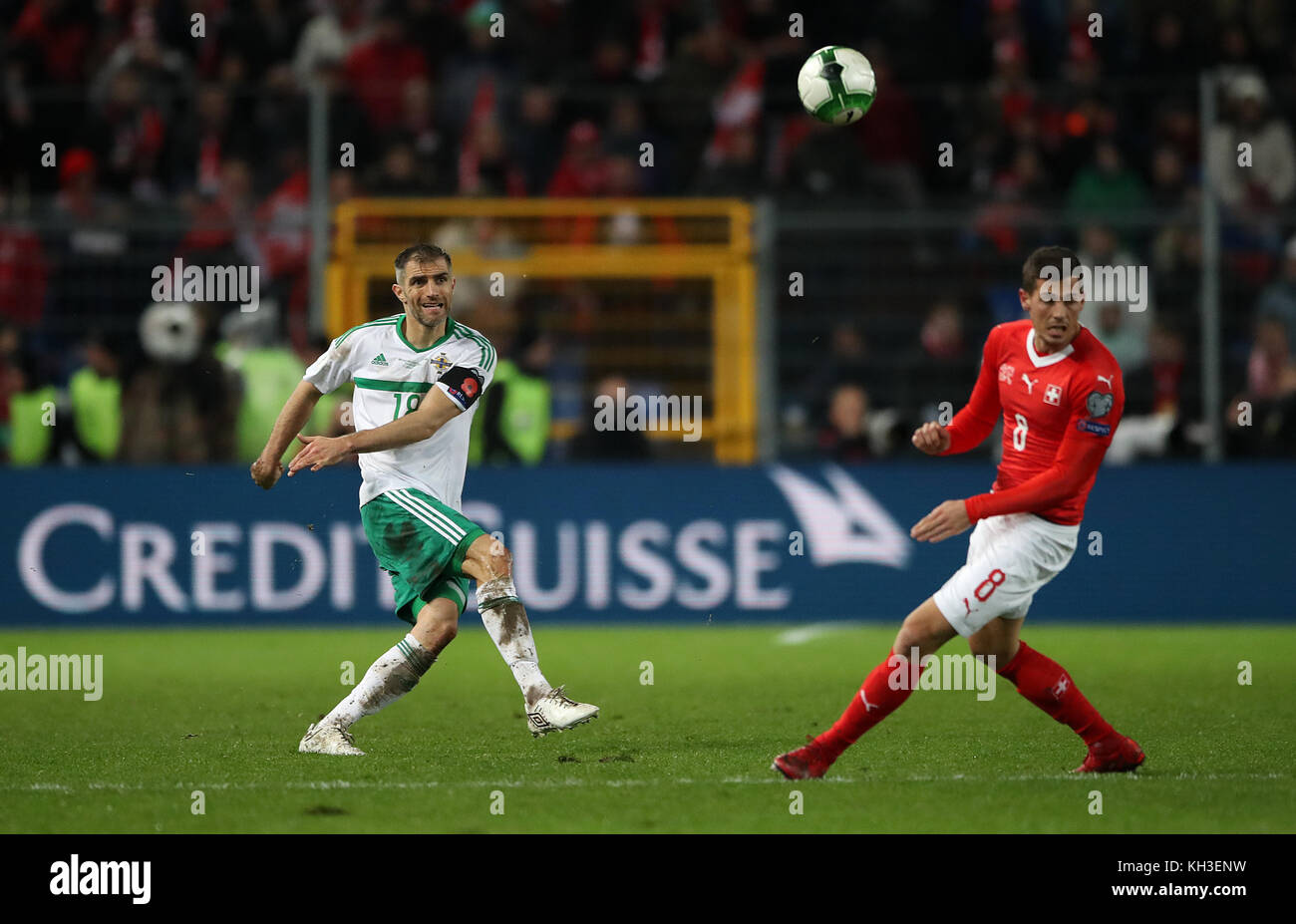 Northern Ireland's Aaron Hughes (left) and Switzerland's Remo Freuler in action during the FIFA World Cup Qualifying second leg match at St Jakob Park, Basel. Stock Photo