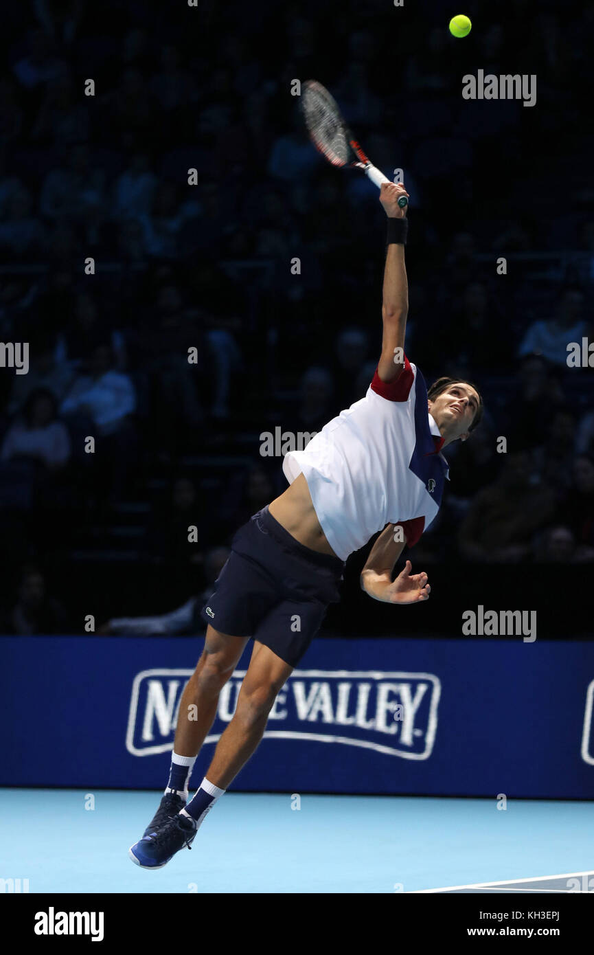 Pierre-Hugues Herbert serves during his doubles match with team mate  Nicolas Mahut against Horia Tecau and Jean-Julien Rojur during day one of  the NITTO ATP World Tour Finals at the O2 Arena,
