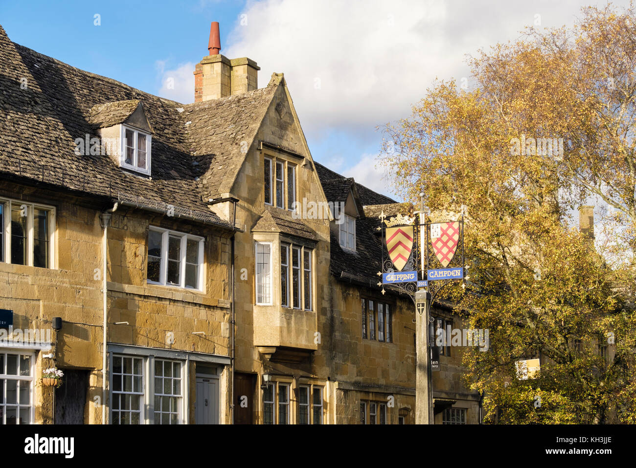 The Cotswolds village name sign and Cotswold stone buildings in