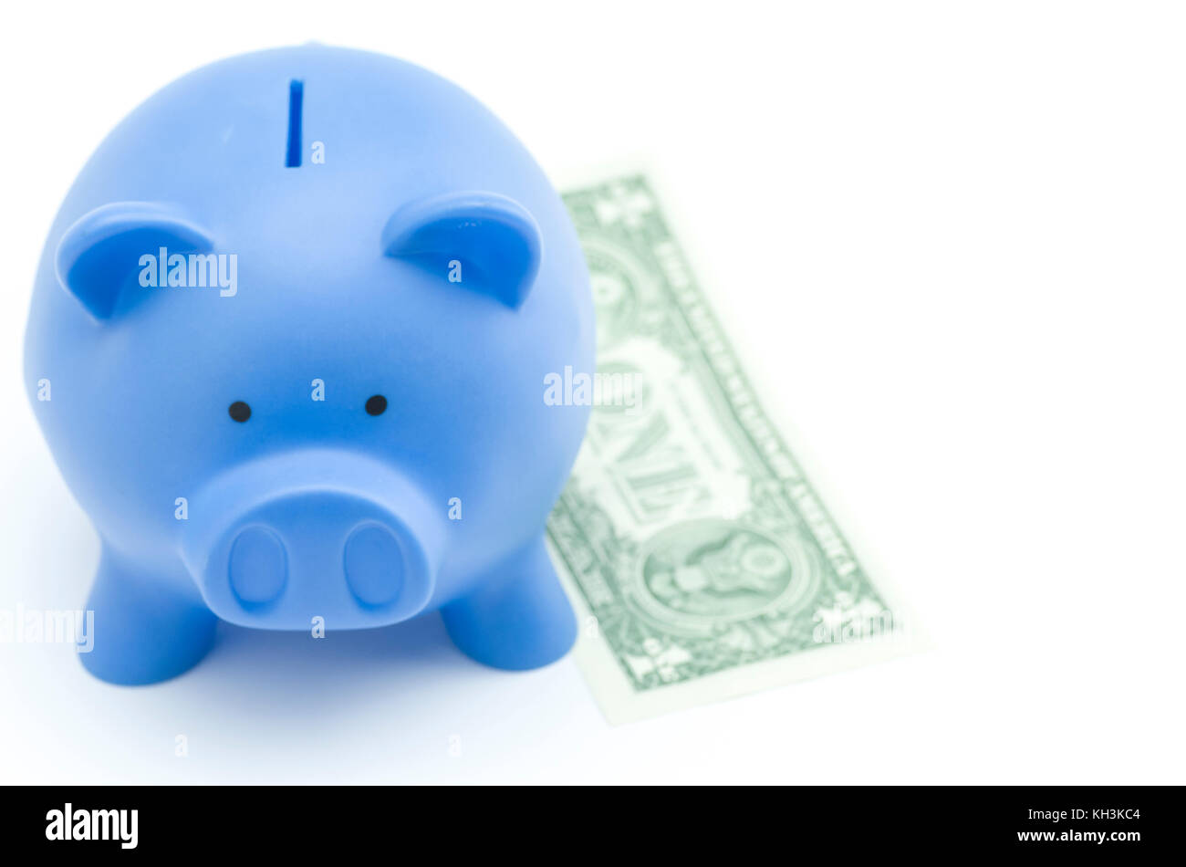 blue piggy bank and banknote on a white background - top view - money ...