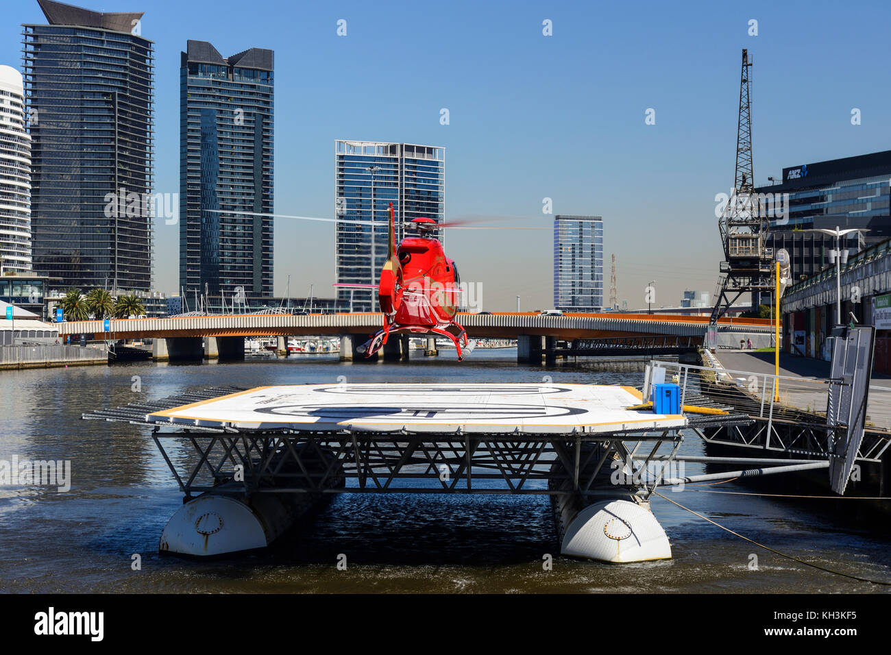 Red city tours helicopter landing on helipad on Yarra River in Melbourne,  Victoria, Australia Stock Photo - Alamy