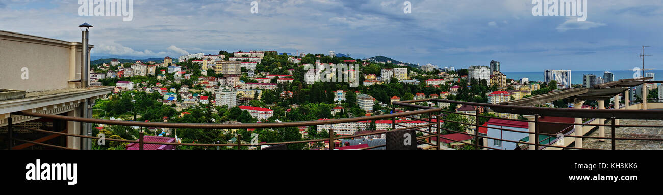 Panorama of Sochi from the air. Houses, streets, trees, the sky are visible. In the distance you can see the sea. Sochi, Russia, cityscape Stock Photo