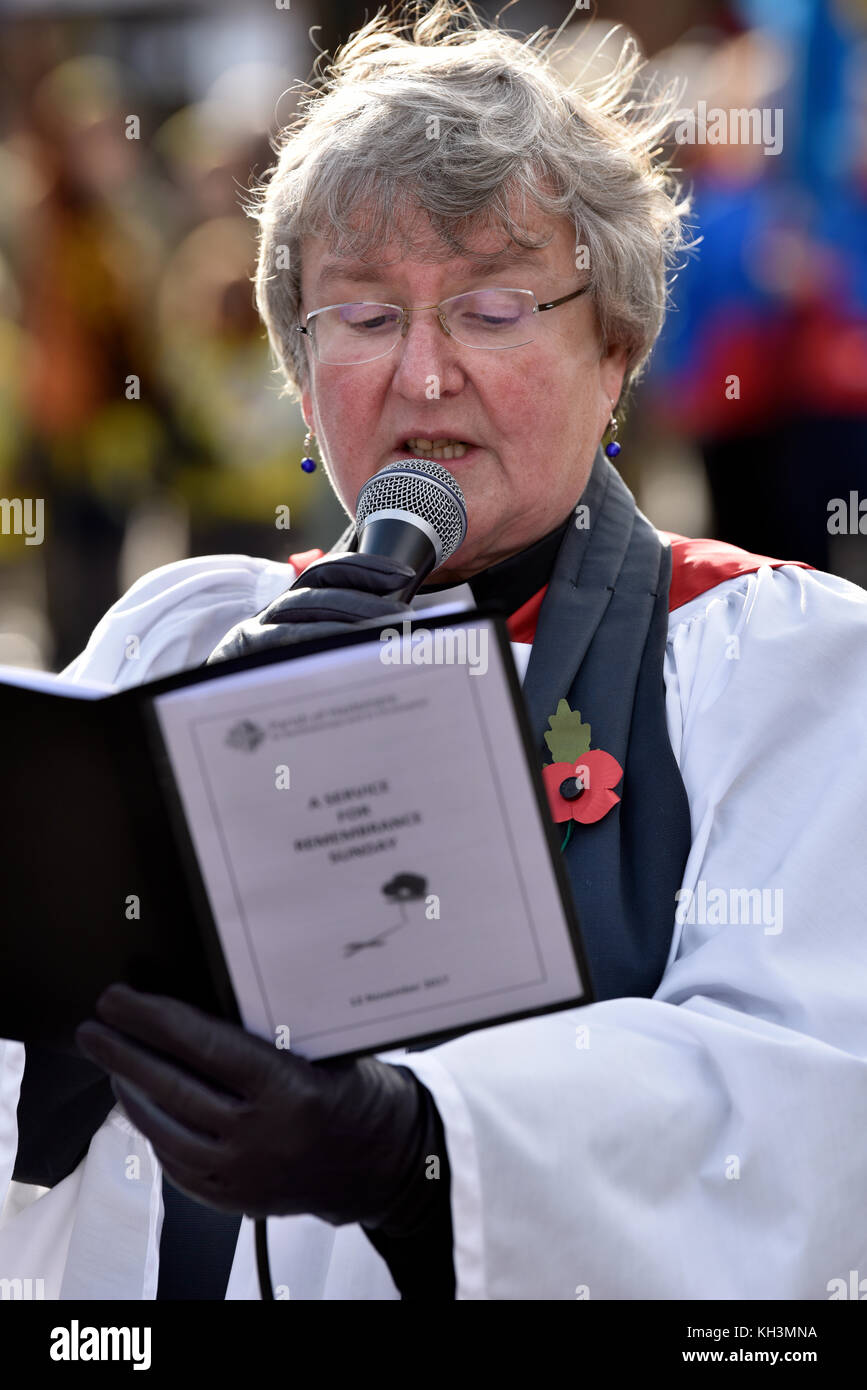 Local Rector delivering a reading on Remembrance Sunday, War Memorial