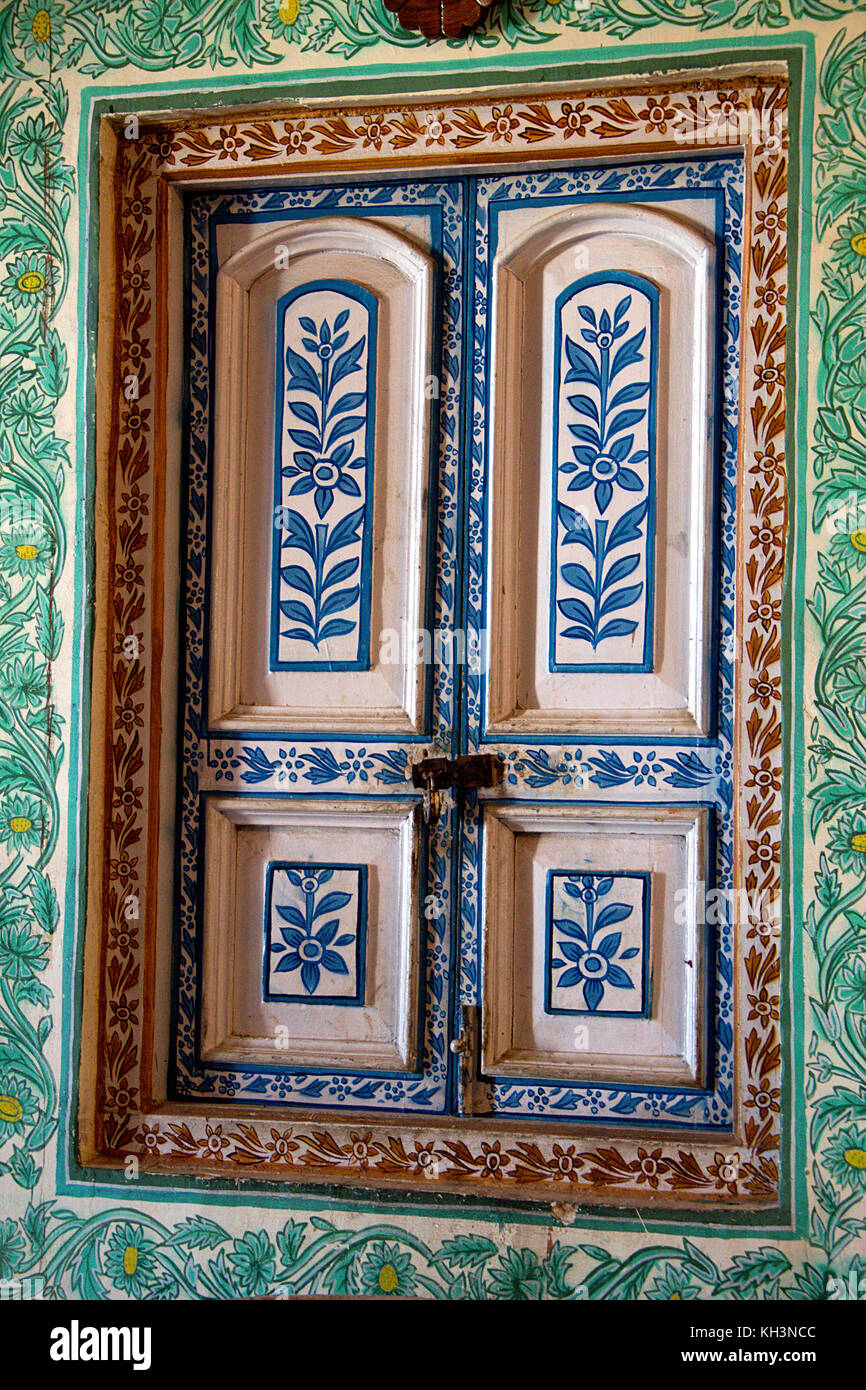 Colorfully decorated window panes and casing with floral design at