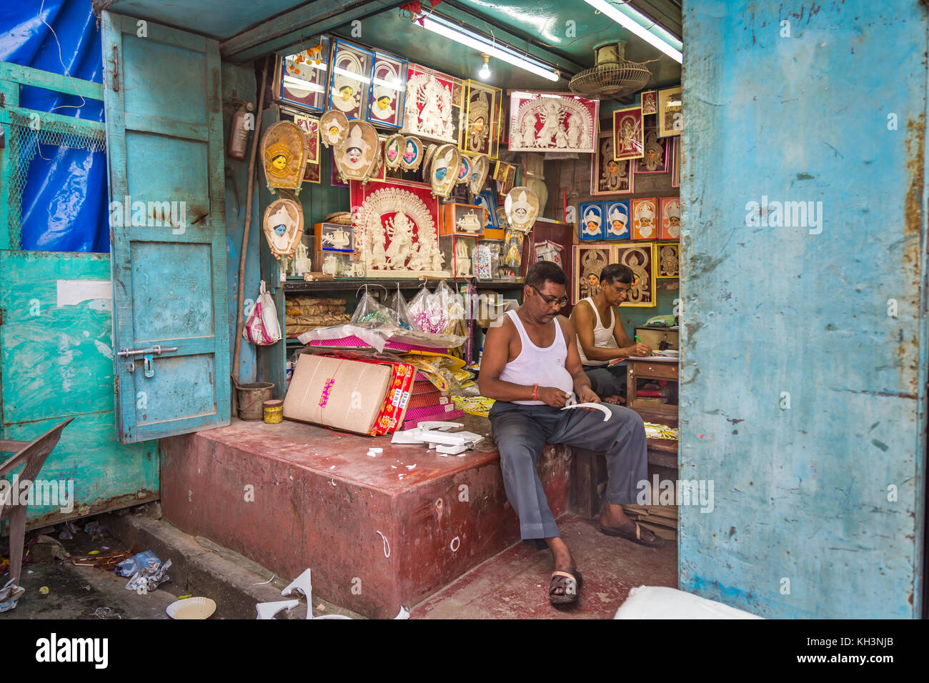 Artisans work on decorative items used on Indian idols and deities in a workshop at Kumartuli area of Kolkata, India. Stock Photo